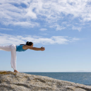 Julia Chen doing yoga on the rocks at the beach near Simonstown, South Africa. Photo: Pierre van der Spuy