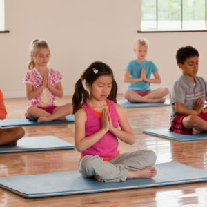 Children exercising in yoga class