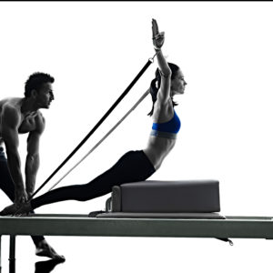 one caucasian couple exercising pilates reformer exercises fitness in silhouette isolated on white backgound