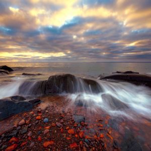 Dramatic beautiful sunrise and cloudy sky over Lake Superior Duluth Minnesota near Brighton Beach